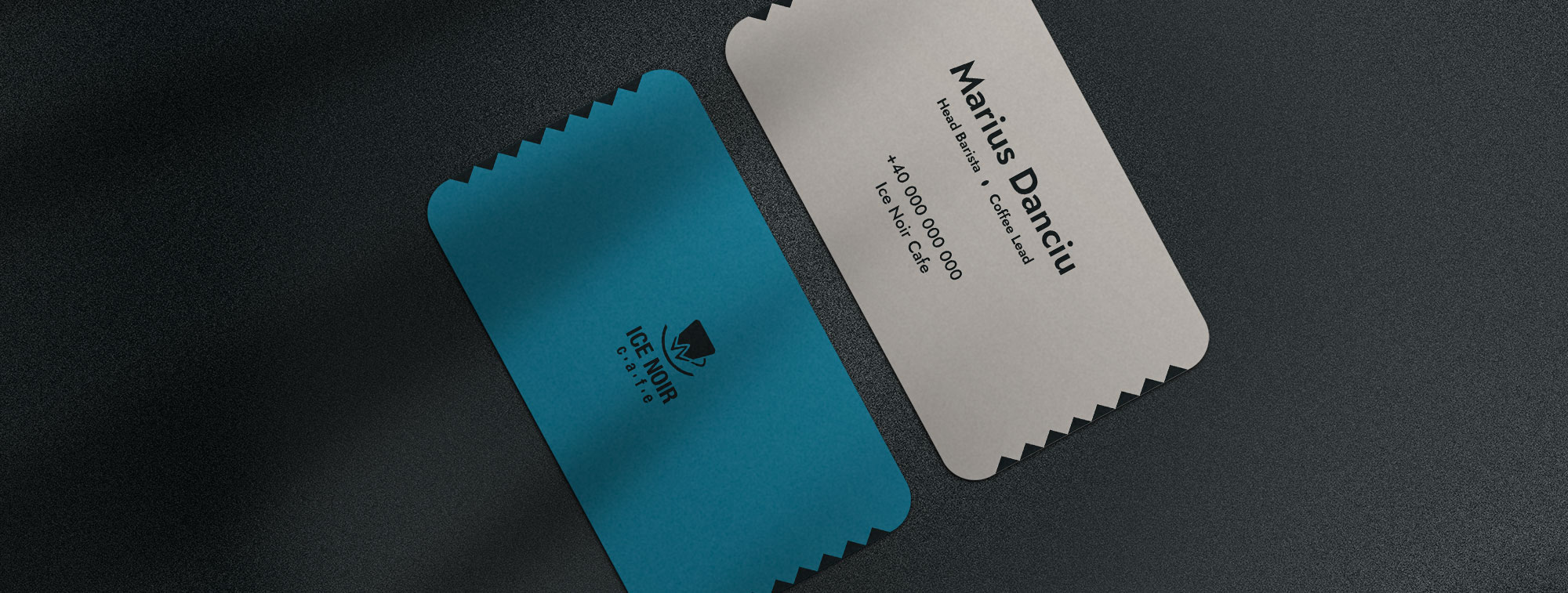 Ice Noir Cafe blue and white sticker labels placed on a dark textured surface
