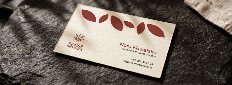 Sense Organica business card mockup on a dark textured surface